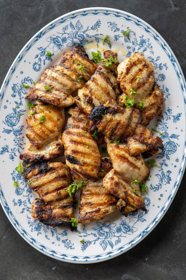 Cuisses de poulet grillées sur une assiette.